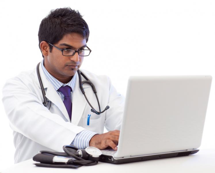 doctor working at laptop